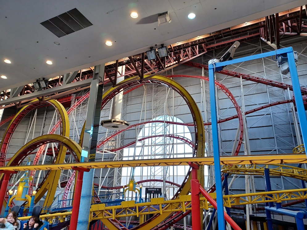 A photo of the Mindbender's loops, slightly obscured by the ceiling and the Galaxy Orbiter's track.