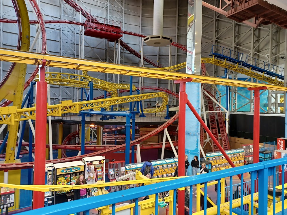 A photo of the Mindbender's right side, with the mirror carousel and chaotic tracks wrapping it.