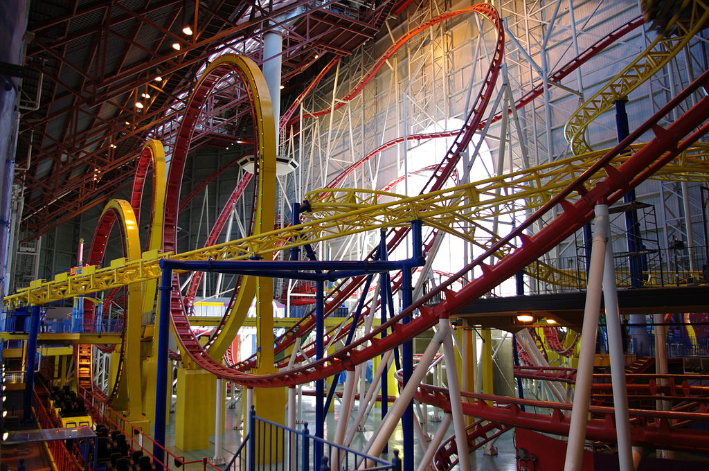 The Minderbender (and part of the Galaxy Orbiter) in Galaxyland located in the West Edmonton Mall. The Mindbender was the tallest indoor coaster, and is a yellow rollercoaster with a bright red track. It's best identified with it's 3 loops.