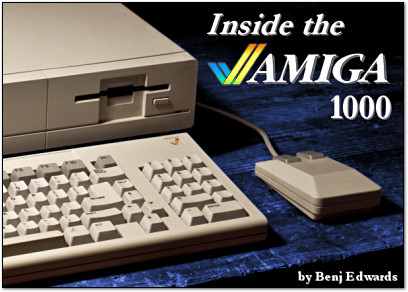 A photo of the Amiga 1000, a cream computer. It is of it's lower right half, showing a disk drive, half of its keyboard, and a boxy classic mouse.