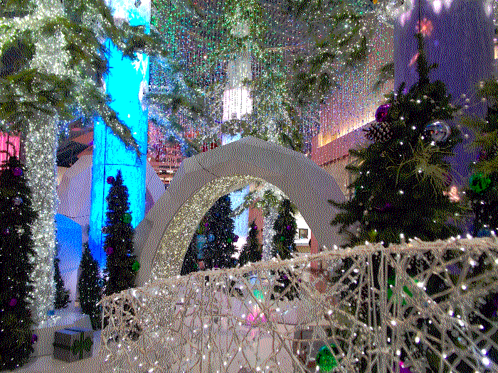 From the bridge of the aforementioned display, focusing on an arch in the middle of the trees and lights.